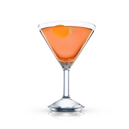 Temptation in a martini glass with an orange twist on white background