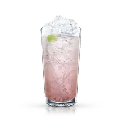 Tequila Caliente served in a highball glass with crushed ice and a lime wedge on white background
