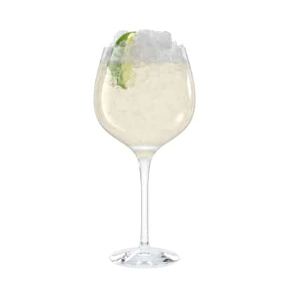 Tequila Fix in a stemmed wine glass with crushed ice and a lime wedge