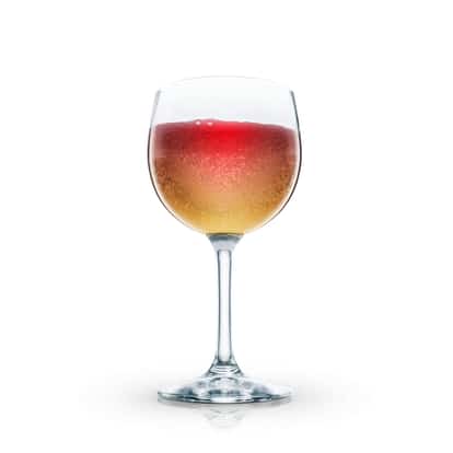 Turkish Blood cocktail in a large wine glass with layered red and amber liquid on white background.