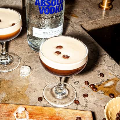 Classic Espresso Martini next to a bottle of Absolut Vodka.