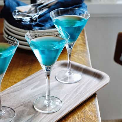 Volga, Volga in three martini glasses on a wooden tray with an Absolut Vodka bottle visible