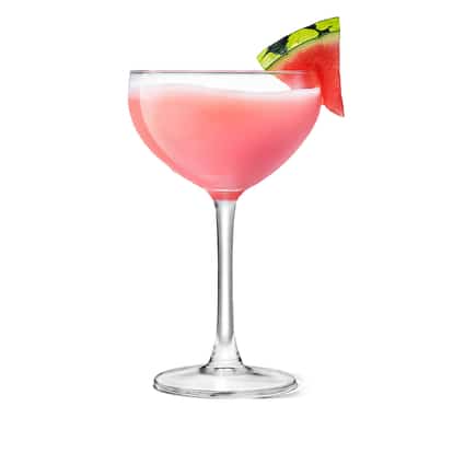 Watermelon Vodka Cocktail in a coupe glass with a watermelon wedge on the rim on white background