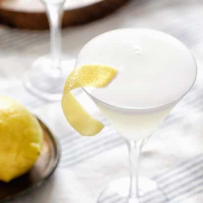 White Lady in a coupe glass with foam and lemon twist