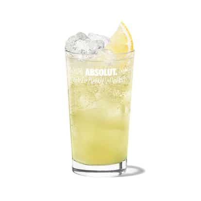 Yo Ho served in an Absolut highball glass with crushed ice and lemon wedge on white background