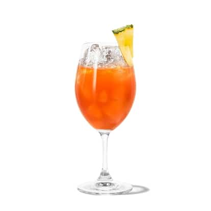 Zombie in a stemmed wine glass with crushed ice and a pineapple wedge