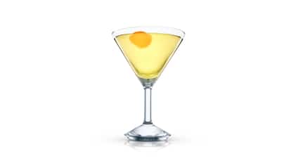 Alaska Martini in a martini glass with orange peel on white background