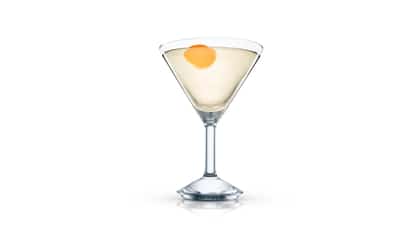 Aqueduct in a martini glass with an orange peel on white background.