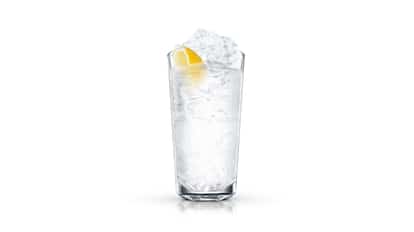 Bahamas Highball in a highball glass with ice and a lemon wedge on white background