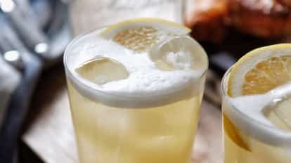Bakery Sour in a rocks glass with foamy top, lemon slice and ice cubes