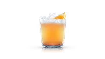 Bakunin in an Absolut rocks glass with crushed ice and an orange wedge on white background