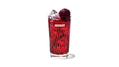 Beet & Breeze in an Absolut highball glass with a beet garnish and ice on white background