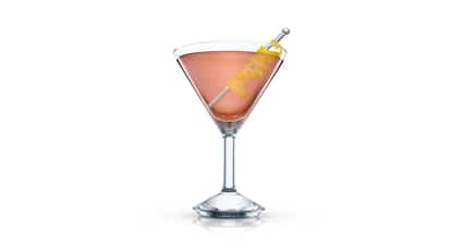 Believe It Or Not served in a martini glass garnished with a lemon twist on a metal pick on white background