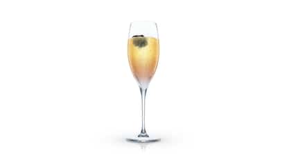 Blackberry Bellini in a champagne flute with a blackberry garnish on white background