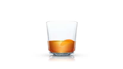 Blueberry Tea in an Absolut rocks glass with an orange peel on white background