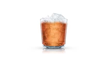 Bowling in an Absolut rocks glass with ice on white background