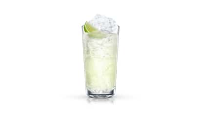 Absolut Citron Lime and Lime in a highball glass with crushed ice and a lime wedge on white background