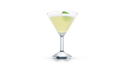 Clover Leaf in a martini glass with a single leaf garnish on white background