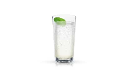 Disco Jean Fizz in a tall highball glass topped with a mint leaf on white background
