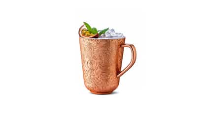 Copper Cup #16 in a copper mug with crushed ice, halved passionfruit and mint sprig on white background