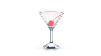 Extasis in a martini glass with a stemmed cherry on white background