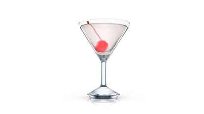 Frankenstein in a martini glass with a cherry on a pick on white background