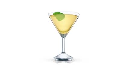 Frisky Bison cocktail in a martini glass with a mint leaf garnish on white background.