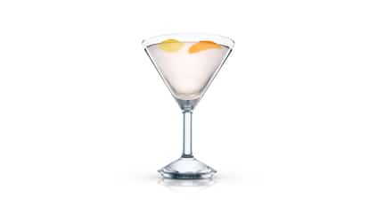 Golden Tear cocktail in an Absolut martini glass garnished with lemon and orange peels on white background
