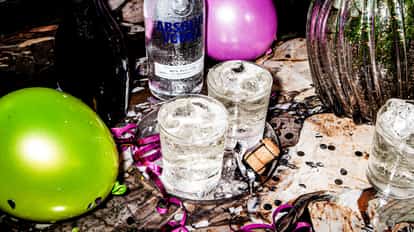 Highroller in three ice-filled rocks glasses on a marble surface with an Absolut Vodka bottle behind
