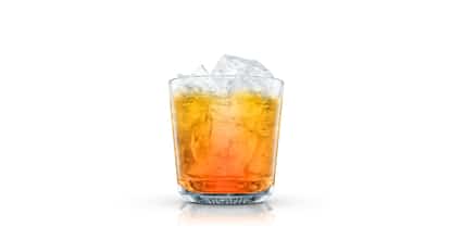 Italian Stinger in an Absolut rocks glass with ice on white background