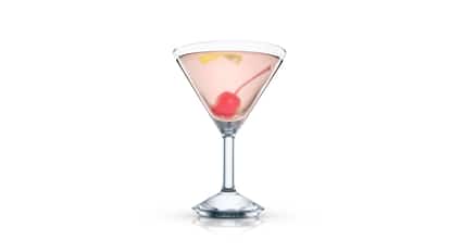 Journalist in a martini glass with a maraschino cherry and a lemon twist on white background