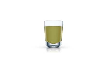 Kiwi Shooter served in a shot glass on white background