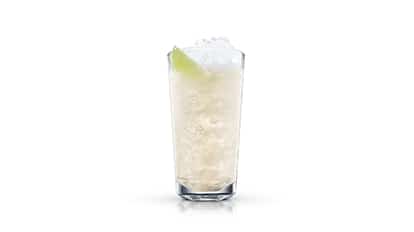 Light and Calm in a highball glass with crushed ice and a lime wedge on white background