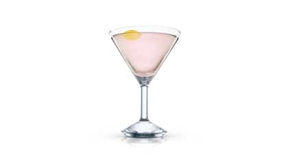 New Fashioned in a martini glass with a lemon twist on white background