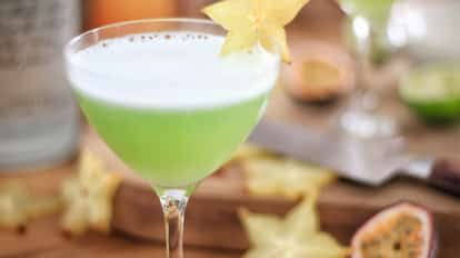 Not-So-Cosmopolitan in a coupe glass with foam and a starfruit slice on the rim