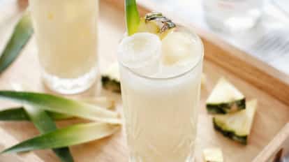 Pina Colada cocktails surrounded by fresh pineapple