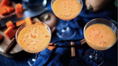 Three Pumpkin Pie Martini cocktail in martini glasses.