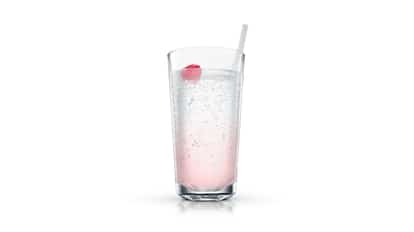Raspberri Butterfly in a highball glass with a straw and a raspberry on white background