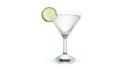 Sakini in a martini glass with a cucumber slice on white background