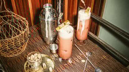 Singapore Sling cocktail beside a Cobber Shaker.