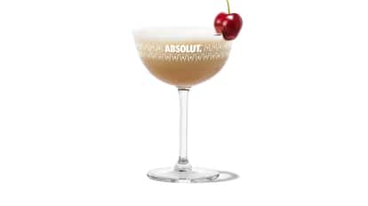 South of The Border in an Absolut coupe glass with foam and a cherry garnish