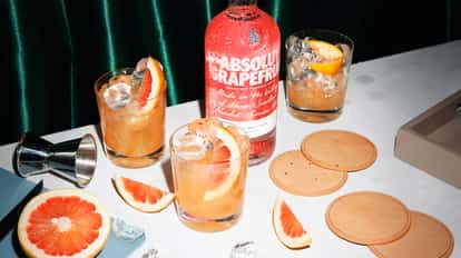 image with two orange cocktails and a bottle of Absolut Grapefruit