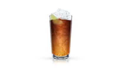 Whisky Cola in a highball glass with crushed ice and a lime wedge on white background